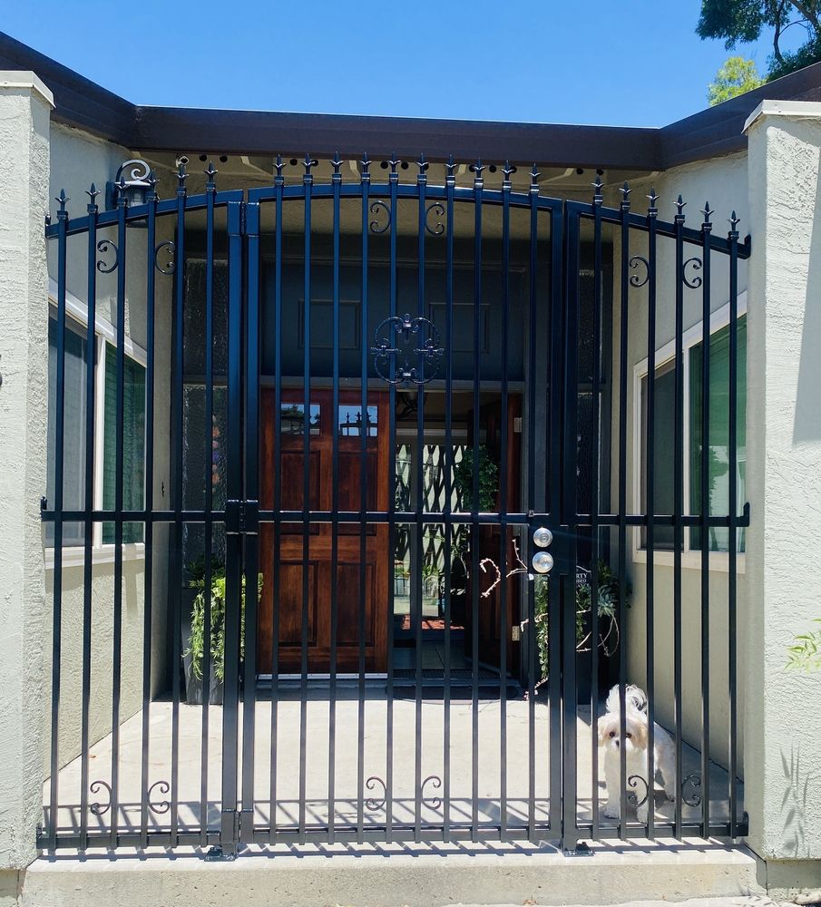 Custom black metal gate installed at the front entry, first view