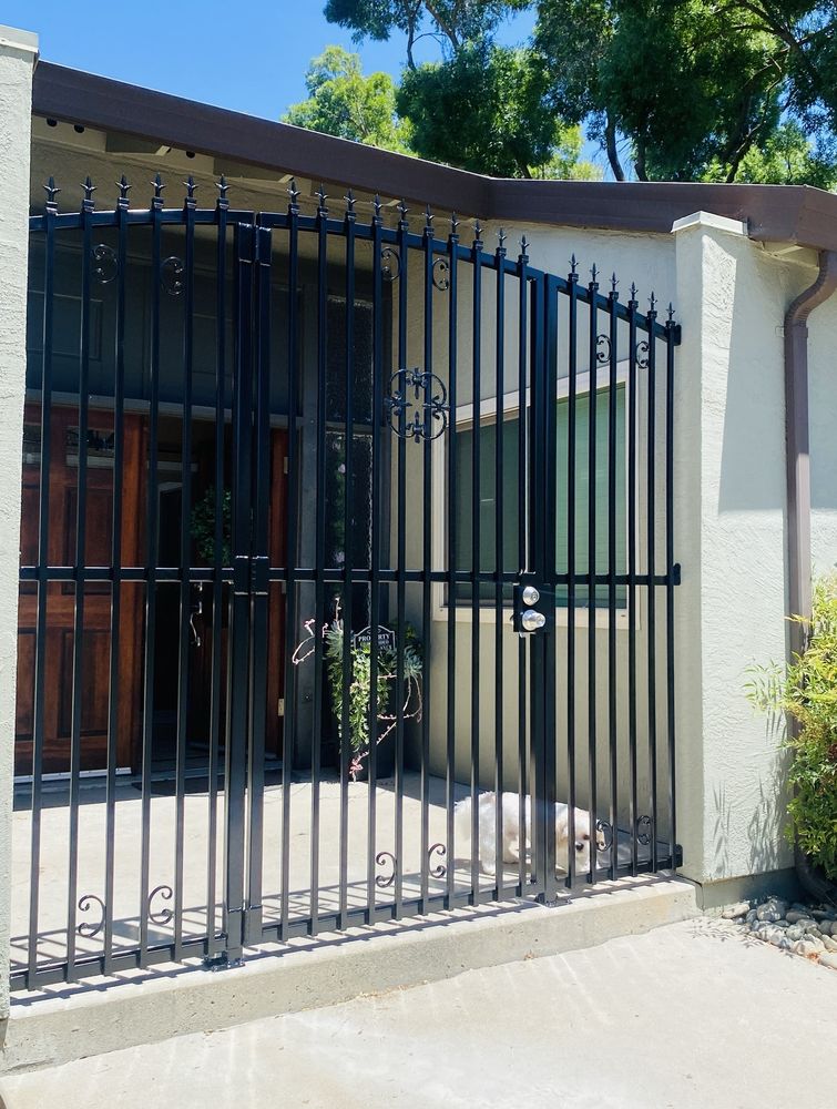 Custom black metal gate installed at the front entry, second view